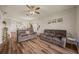 Living room with comfortable seating, view of the kitchen, and holiday decorations at 6937 Exeter Park Pl, Apollo Beach, FL 33572