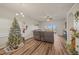 Spacious living area decorated for the holidays with a Christmas tree and view of the backyard at 6937 Exeter Park Pl, Apollo Beach, FL 33572