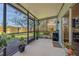 Enjoy the Florida weather on this covered, screened porch overlooking the backyard at 6937 Exeter Park Pl, Apollo Beach, FL 33572