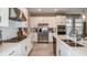 Bright, spacious kitchen with stainless steel appliances, white cabinets, and a quartz countertop island at 708 Sky Shade Dr, Apollo Beach, FL 33572