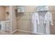 Laundry room with washer, dryer, hanging rack, and shelves at 708 Sky Shade Dr, Apollo Beach, FL 33572