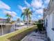 Backyard oasis featuring a boat dock, lush landscaping, and stunning water views at 8723 Hickorywood Ln, Tampa, FL 33615