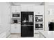 Kitchen with white cabinetry, black appliances, and built-in microwave and oven at 8750 Ivy Stark Blvd, Wesley Chapel, FL 33545