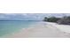 Peaceful beach scene with calm water, white sand, and boat in the distance at 880 Mandalay Ave # C314, Clearwater Beach, FL 33767