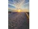 Peaceful beach scene with footprints in the sand at sunset at 880 Mandalay Ave # C314, Clearwater Beach, FL 33767