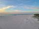 Peaceful beach scene at sunset with soft sand and ocean waves at 880 Mandalay Ave # C314, Clearwater Beach, FL 33767