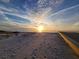 Scenic sunset over the beach with boardwalk and footprints in the sand at 880 Mandalay Ave # C314, Clearwater Beach, FL 33767