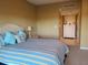 Comfortable bedroom with striped bedding and ample storage at 880 Mandalay Ave # C314, Clearwater Beach, FL 33767