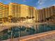 Building exterior with pool and palm trees at 880 Mandalay Ave # C314, Clearwater Beach, FL 33767