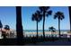 Oceanfront pool and lounge area with palm trees and beach access at 880 Mandalay Ave # C314, Clearwater Beach, FL 33767