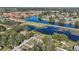 Aerial view of a house near a canal with surrounding neighborhood and lush greenery at 930 N Conrad Ave, Sarasota, FL 34237