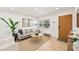 Living room featuring a gray sofa and wooden coffee table, near the entryway at 930 N Conrad Ave, Sarasota, FL 34237