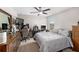 Bedroom featuring a ceiling fan, neutral carpet and a large gaming setup at 9334 Lemon Drop Loop, Sun City Center, FL 33573