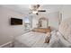 Spacious bedroom with a large bed, dresser, and a mounted TV at 9334 Lemon Drop Loop, Sun City Center, FL 33573