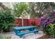 Peaceful backyard with picnic table, lush landscaping, and a wooden fence at 9703 33Rd E Ave, Palmetto, FL 34221