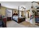 Bright bedroom featuring a large four-poster bed and ample space at 9703 33Rd E Ave, Palmetto, FL 34221