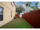Side yard with access gate and a brown wooden fence at 9703 33Rd E Ave, Palmetto, FL 34221