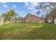Spacious backyard with lush green lawn and screened lanai at 10101 Paddock Oaks Dr, Riverview, FL 33569