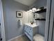 Stylish bathroom with a vanity, floating shelves, decorative lighting, and a neutral color palette at 10101 Paddock Oaks Dr, Riverview, FL 33569