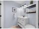 Well-lit bathroom with white vanity, shelves, and modern fixtures at 10101 Paddock Oaks Dr, Riverview, FL 33569