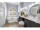 Elegant bathroom featuring a soaking tub, double vanity, and modern fixtures, offering a spa-like experience at 10101 Paddock Oaks Dr, Riverview, FL 33569