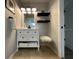 Bathroom featuring a white vanity, floating shelves, and decorative lighting for a spa-like experience at 10101 Paddock Oaks Dr, Riverview, FL 33569
