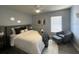 Cozy bedroom features gray walls, an accent chair, ceiling fan, and natural light from a window at 10101 Paddock Oaks Dr, Riverview, FL 33569