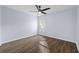 Spacious bedroom with hardwood floors, a ceiling fan, and ample natural light at 10101 Paddock Oaks Dr, Riverview, FL 33569