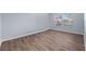 A well-lit bedroom with hardwood flooring, multiple windows and blinds, and neutral decor at 10101 Paddock Oaks Dr, Riverview, FL 33569