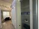 Open closet showcasing multiple shelves with storage items and a view of the main bedroom at 10101 Paddock Oaks Dr, Riverview, FL 33569