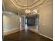 Expansive living area showcasing tray ceilings, elegant lighting and architectural details at 10101 Paddock Oaks Dr, Riverview, FL 33569