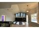 Open living room area with vaulted ceilings, fireplace and a view to the pool area through large windows at 10101 Paddock Oaks Dr, Riverview, FL 33569