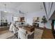 Living room with wood floors, high ceilings, white couches, and a view of the kitchen at 10101 Paddock Oaks Dr, Riverview, FL 33569