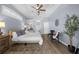 Serene main bedroom featuring a tray ceiling, wood floors, accent lighting, and a sitting area at 10101 Paddock Oaks Dr, Riverview, FL 33569