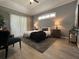 Cozy main bedroom with tray ceiling, natural light, and modern furniture at 10101 Paddock Oaks Dr, Riverview, FL 33569