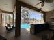 Covered outdoor kitchen and bar area that offers the perfect space for relaxation and entertaining by the pool at 10101 Paddock Oaks Dr, Riverview, FL 33569