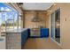 Outdoor kitchen with stainless steel appliances and blue cabinetry next to the pool at 10101 Paddock Oaks Dr, Riverview, FL 33569