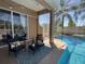 Inviting poolside seating area with comfortable lounge chairs and a view of the refreshing pool and palm trees at 10101 Paddock Oaks Dr, Riverview, FL 33569