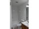 Simple bathroom with tiled walls, a white tub, and a wooden vanity at 10737 Keys Gate Dr, Riverview, FL 33579