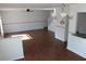 Bright living room with wood-look floors, chandelier, and a ceiling fan at 10737 Keys Gate Dr, Riverview, FL 33579
