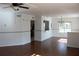 Bright living room with wood-look floors and an open view to the kitchen at 10737 Keys Gate Dr, Riverview, FL 33579