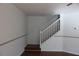 White stairway with wooden handrail in a naturally lit living space at 10737 Keys Gate Dr, Riverview, FL 33579