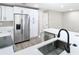 Modern kitchen with white cabinets, stainless steel appliances, and a large island at 12301 Folger St, Spring Hill, FL 34609