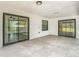Tiled patio with sliding glass doors leading to the pool area at 12301 Folger St, Spring Hill, FL 34609