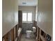 Bathroom featuring tiled floors, toilet, tub, and exposed wall framing at 15816 2Nd St E, Redington Beach, FL 33708
