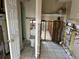 Bathroom featuring a toilet, tiled floor, shower, and exposed wall framing at 15816 2Nd St E, Redington Beach, FL 33708