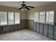This bedroom features plantation shutters, tiled floors, and exposed wall framing at 15816 2Nd St E, Redington Beach, FL 33708