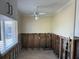 Dining room area with ceiling fan, tile floors, window, and exposed wall framing at 15816 2Nd St E, Redington Beach, FL 33708