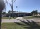 One-story home with a gray exterior, white trim, and a paved driveway at 15816 2Nd St E, Redington Beach, FL 33708