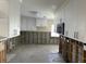 Bright kitchen with white cabinets, modern microwave, tile floors, and exposed wall framing at 15816 2Nd St E, Redington Beach, FL 33708